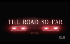 A still of the rear of the Impala from the CW show Supernatural with the words "The Road So Far" across it
