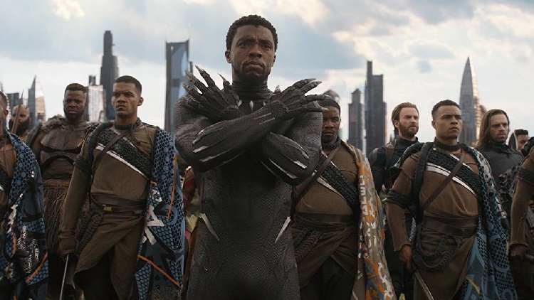 Chadwick Boseman executing the Wakanda salute as Black Panther