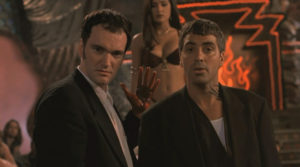 A still from the movie, From Dusk Till Dawn, featuring Quentin Tarantino, Salma Hayek, and George Clooney