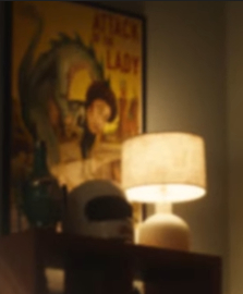poster of a dragon with a woman's head and a helmet on a shelf