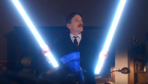 Nikola Tesla (Ethan Hawke) holds a pair of glowing tubes in a still from the 2020 film "Tesla."