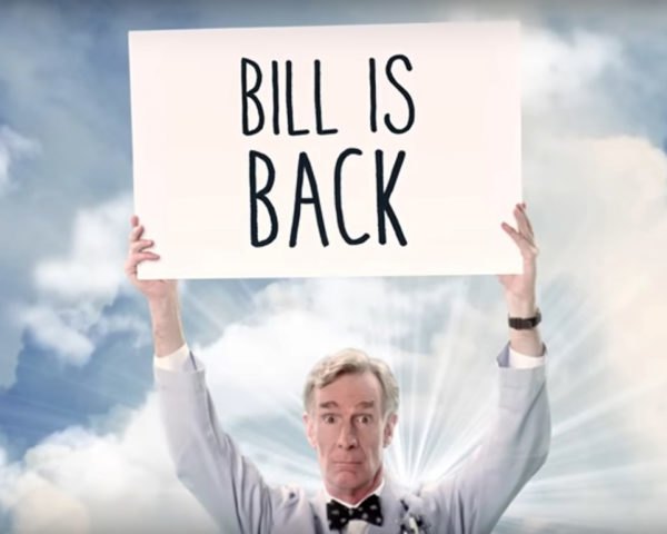 Bill Nye holding a sign saying BIll is Back