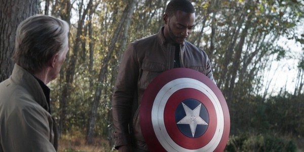 Steve Rogers (Chris Evans) passes the mantle of Captain America, as well as the shield, to Sam Wilson (Anthony Mackie) in a still from "Avengers Endgame."