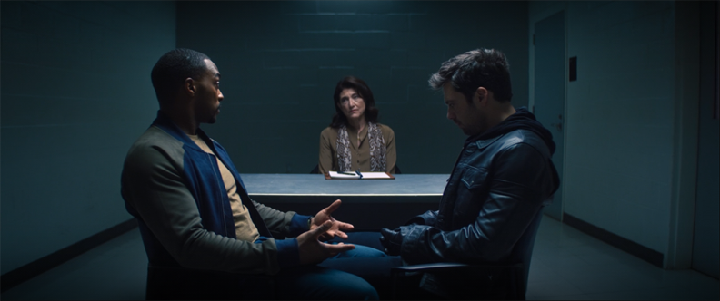 Sam (Anthony Mackie) and Bucky (Sebastian Stan) undergo couples therapy led by Dr. Raynor (Amy Aquino) in a still from "The Falcon and the Winter Solder" on Disney+.