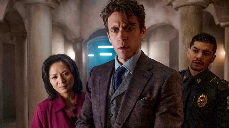 Inoue Sato (Sumalee Montano), Robert Langdon (Ashley Zukerman, and Nunez (Rick Gonzalez) puzzle over a mystery in a still from the upcoming Peacock series 
