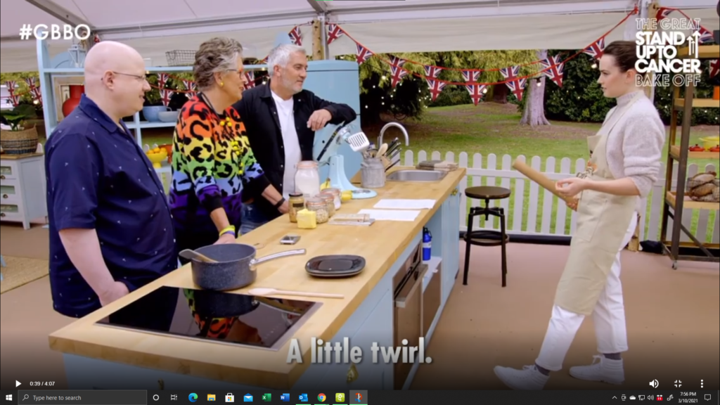 Daisy Ridley shows off a simple lightsaber technique to Bake Off judges Paul Hollywood, Prue Leith and host Mat Lucas.
