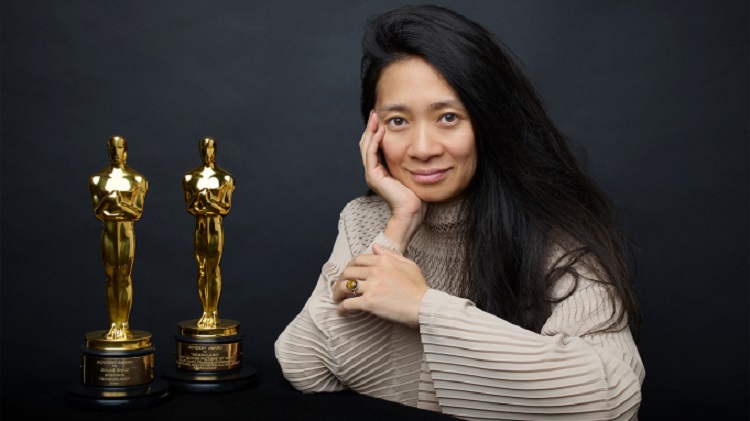 Chloé Zhao with two Oscars as photographed by Andrew Eccles for Variety