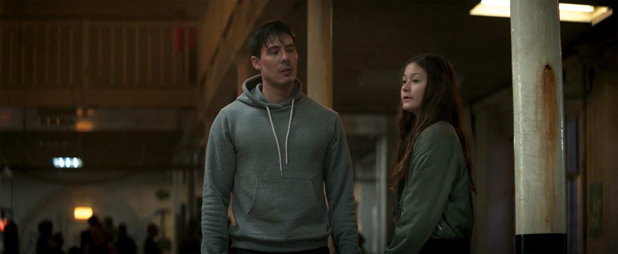 Cole Young (Lewis Tan) is consoled by his daughter Emily (Matilda Kimber) after losing a match in a still from the New Line Cinemas film "Mortal Kombat."