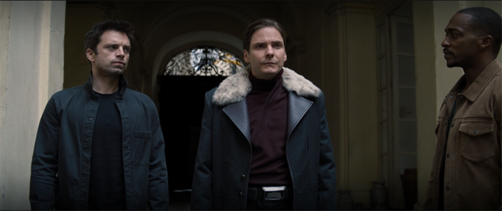 Bucky (Sebastian Stan), Zemo (Daniel Bruhl), and Sam (Anthony Mackie) search a courtyard for Karli Morgenthau in a still from "The Falcon and the Winter Soldier" on Disney+.