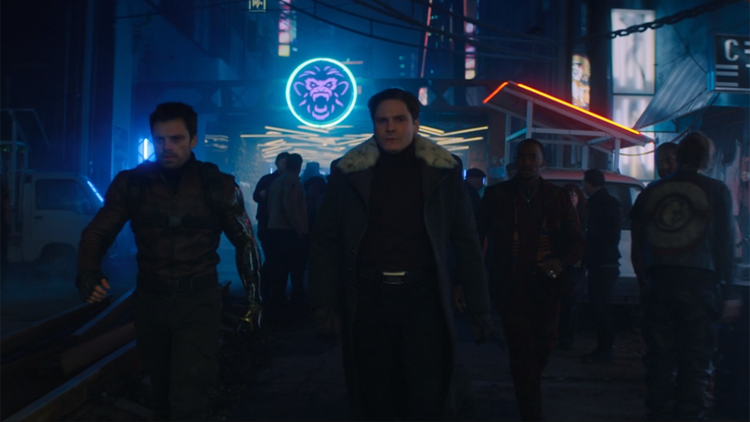 Bucky (Sebastian Stan), Zemo, Daniel Brühl), and Sam (Anthony Mackie) walk through the neon streets of Madripoor in a still from the Disney+ show "The Falcon and the Winter Soldier."