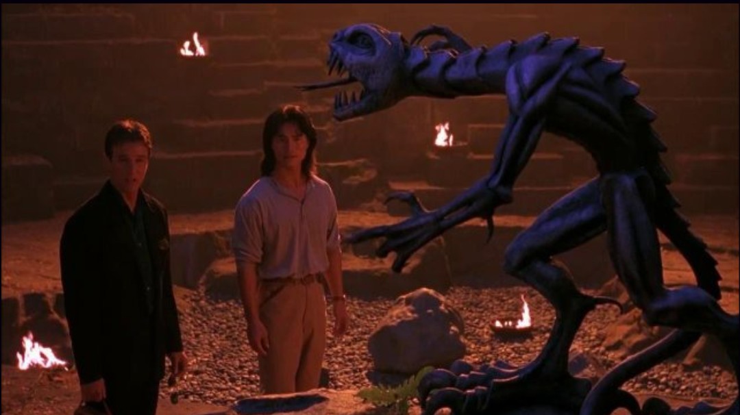 Johnny Cage (Linden Ashby) and Liu Kang (Robin Shou) look at an eerie statue of Reptile in a still from the 1995 film "Mortal Kombat."