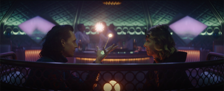 Loki (Tom Hiddleston) and Sylvie (Sophia Di Martino) discuss their lives and what makes them different in a still from the Disney+ series "Loki."
