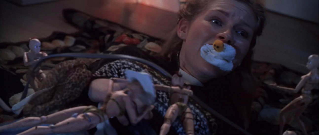 Christy Fimple (Kirsten Dunst) is attacked by a swarm of Gwendy dolls in a still from the 1998 film "Small Soldiers."