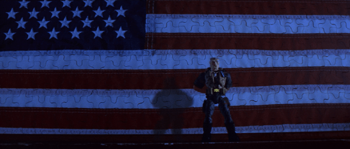 Chip Hazard (voiced by Tommy Lee Jones) gives a rousing speech in front of an American flag a la "Patton" in a still from the 1998 film "Small Soldiers."