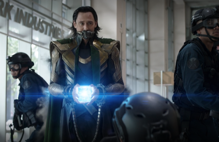 Loki (Tom Hiddleston) steals the Tesseract and uses it to escape from the Avengers in a still from the Disney+ series "Loki."