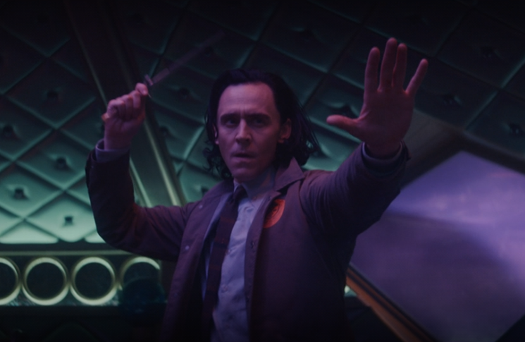Loki (Tom Hiddleston) prepares to throw one of his signature daggers in a still from the Disney+ series 