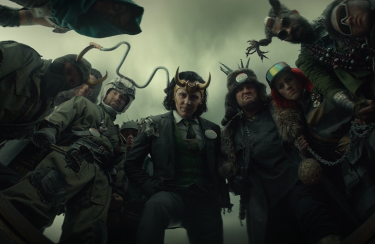 President Loki (Tom Hiddleston) and his band of minions look down on 2012 Loki in a still from the Disney+ series 
