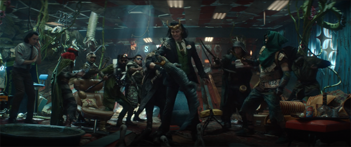 President Loki (Tom Hiddleston) gets his hand bitten off by Crocodile in a still from the Disney+ series "Loki."