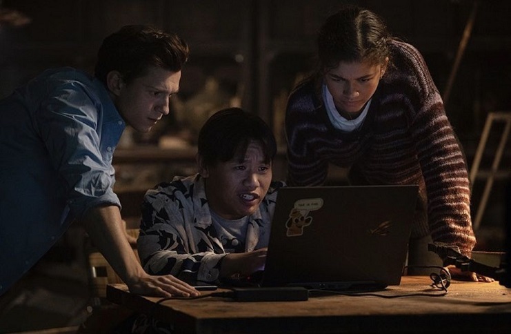 Tom Holland, Jacob Batalon, And Zendaya gathered around laptop In 'Spider-Man: No Way Home'