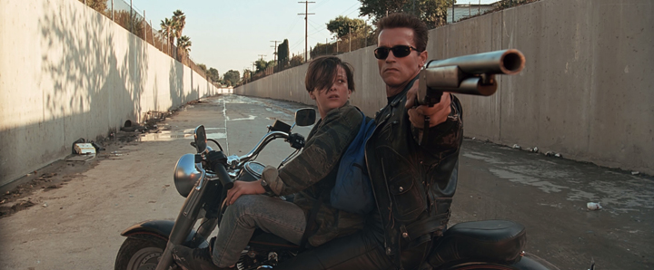 The T-800 (Arnold Schwarzenegger) protects John Connor (Edward Furlong) from the liquid metal T-1000 in a scene from the 1991 classic film "Terminator 2: Judgement Day."