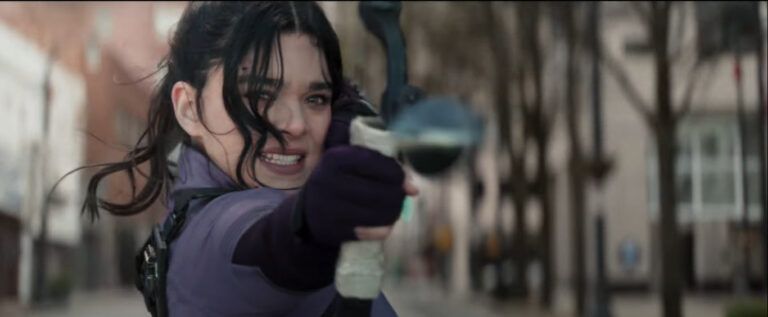 Kate Bishop (Kailee Steinfeld) readies an arrow from a moving car in a still from the trailer for 
