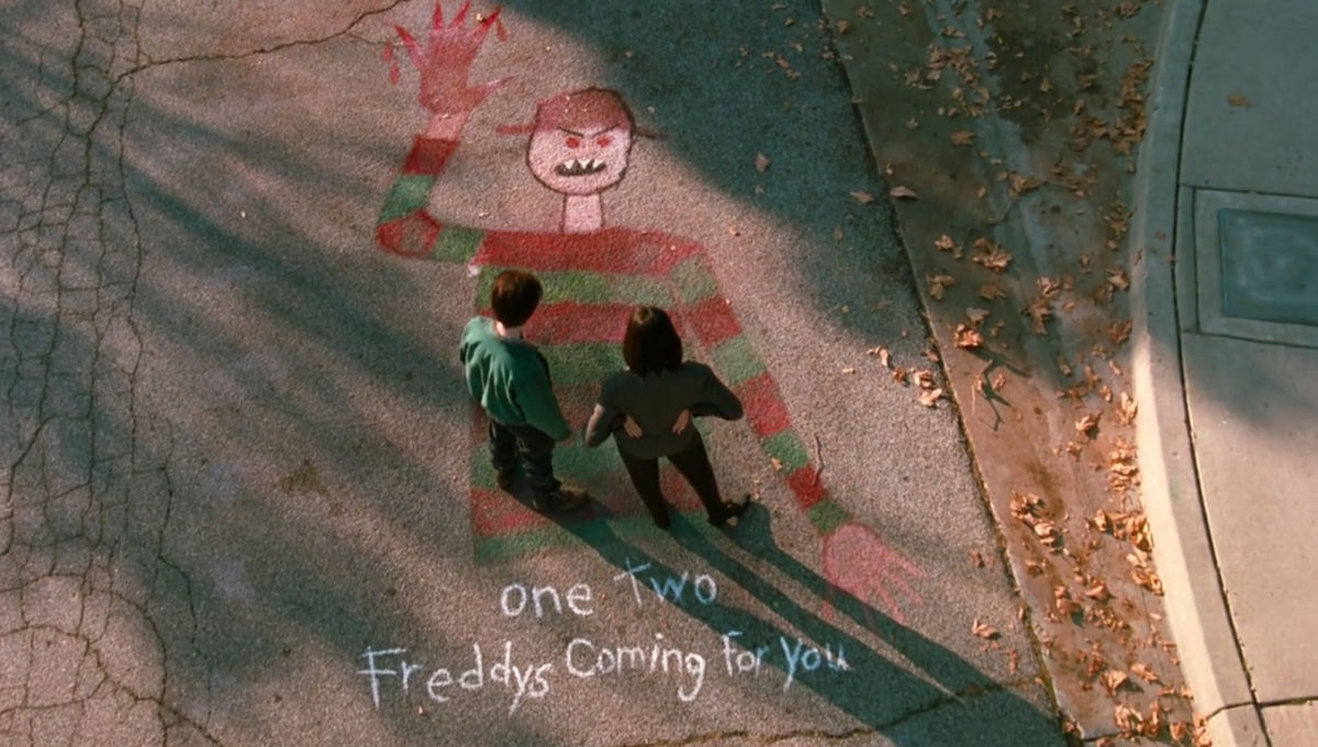 Maggie (Lisa Zane) and John (Shon Greenblatt) examine a chalk drawing of Freddy Kruger in a still from "Freddy's Dead: The Final Nightmare."