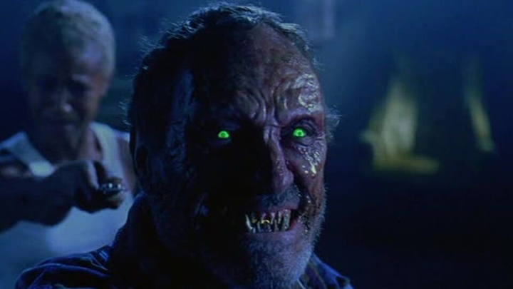 Uncle Willy (Dick Miller) turns to Hell's side after being attacked by demons a still from "Tales from the Crypt: Demon Knight."