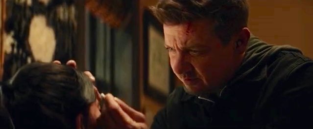 Clint Barton (Jeremy Renner) tends to Kate Bishop's (Hailee Steinfeld) wounds after her fight with the Tracksuit Mafia in a still from the Disney+ series "Hawkeye."