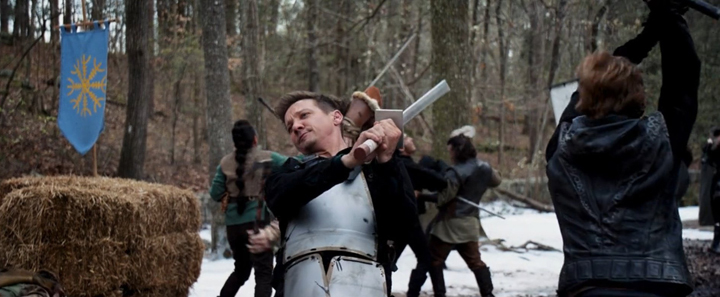 Clint Barton (Jeremy Renner) uses his fighting skills to best a group of LARPers in a still from the Disney+ series "Hawkeye."