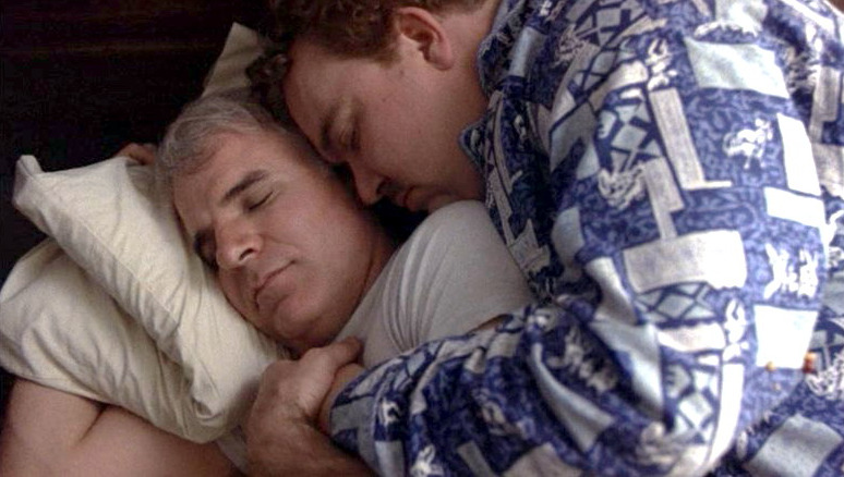 Del Griffith (John Candy) finds himself spooning Neal Page (Steve Martin) when the two are forced to share a hotel roomin a still from "Planes, Trains and Automobiles."
