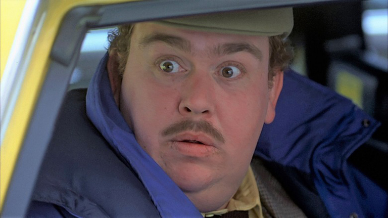 Del Griffith (John Candy) is frightened by a frothing Neal Page (Steve Martin after accidently taking his cab in "Planes, Trains and Automobiles."
