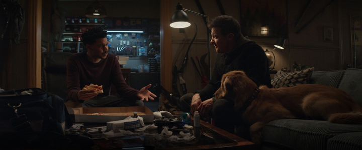 Grills (Clayton English) gives Clint Barton (Jeremy Renner) and Lucky the Pizza Dog a place to crash in a still from the Disney+ series "Hawkeye."