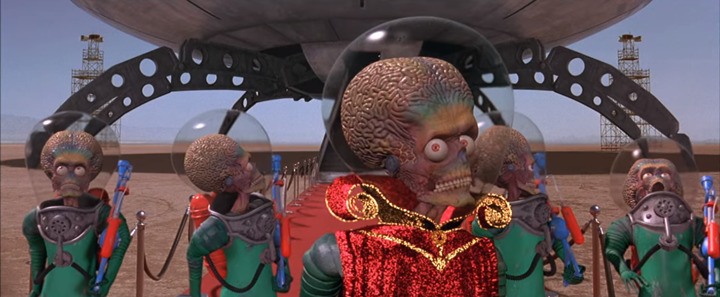 The aliens are surprised to hear their language broadcasted back to them in a scene from the Tim Burton film "Mars Attacks!"