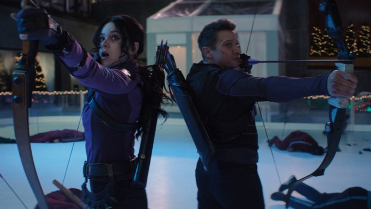 Kate Bishop (Hailee Steinfeld) and Clint Barton (Jeremy Renner) fight off the entirety of the Tracksuit mafia with trick arrows in a still from the Disney+ show "Hawkeye."