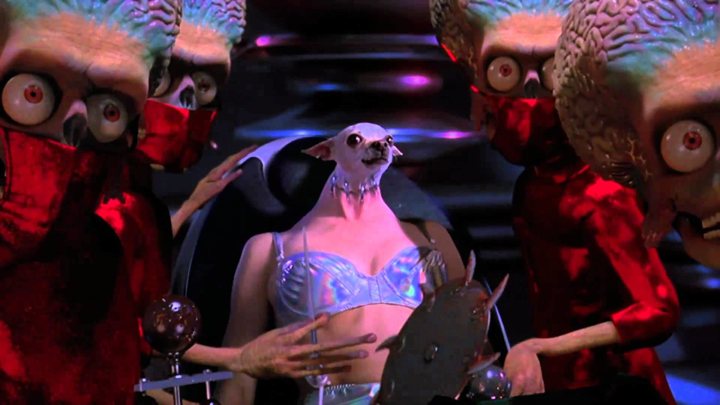 The aliens perform grotesque experiments on the humans, like transplanting a dog's head onto Sarah Jessica Parker's body, in a scene from the Tim Burton film "Mars Attacks!"