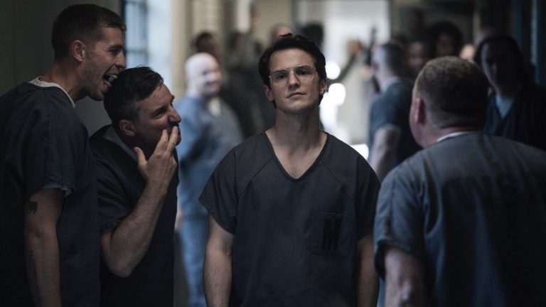 Vigilante (Freddie Stroma) strolls confidently through the jail with a plan to kill Peacemaker's father in a still from HBOMax's "Peacemaker."
