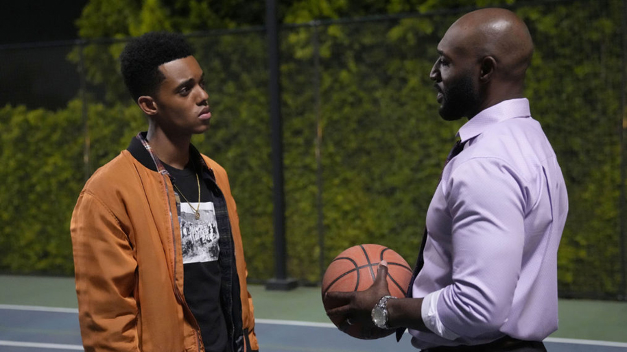 Will (Jabari Banks) discusses his past with Uncle Phil (Adrian Holmes) on the basketball court in a still from the Peacock series "Bel Air."