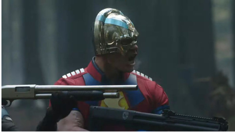 Peacemaker (John Cena) takes aim with a shotgun in a still from the HBOMax show "Peacemaker."