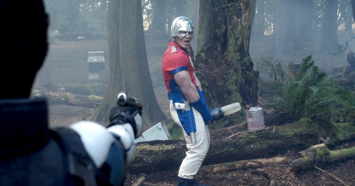 Peacemaker (John Cena) taunts Vigilante with a blender during an outdoor target practice in a still from the HBOMax show "Peacemaker."