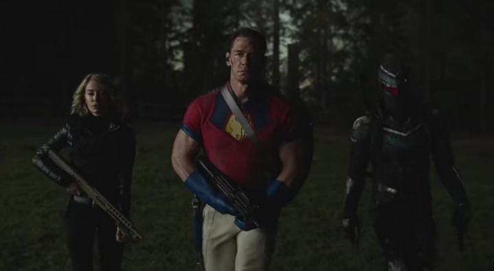 Harcourt (Jennifer Holland), Peacemaker (John Cena), and Vigilante (Freddie Stroma) storm into battle in a still from the HBOMax series "Peacemaker."