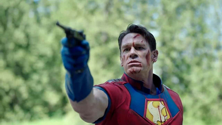Peacemaker (John Cena) levels a World War 2 era gun on the White Dragon a still from the HBOMax series "Peacemaker."