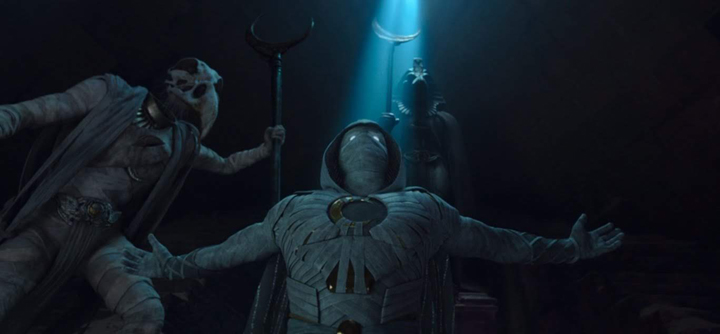 Marc Spector (Oscar Isaac) rises triumphantly after Khonshu imbues him with power and saves him from death in a still from the Disney+ series "Moon Knight."