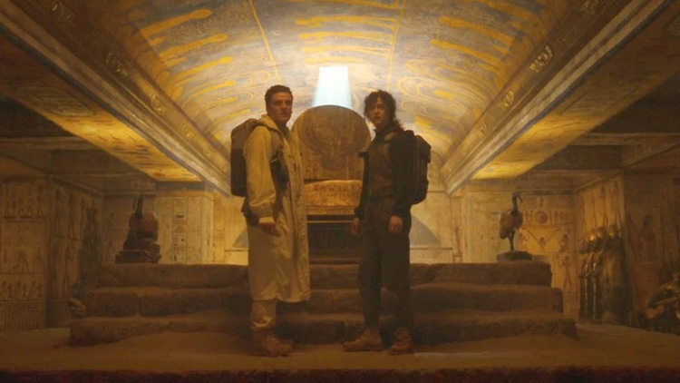 Marc Spector (Oscar Isaac) and Layla (May Calamawy) stand in front of an ancient sarcophagus in a still from the Disney+ series "Moon Knight."
